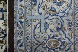 Backside of handmade 2000s Kashan rug showing knot structure and weave density
