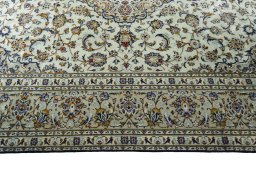 Corner detail of 2000s Kashan rug showing border pattern and Wool pile