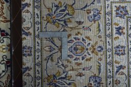 Backside of handmade 2000s Kashan rug showing knot structure and weave density
