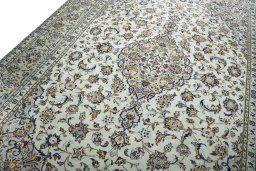 Backside of handmade 2000s Kashan rug showing knot structure and weave density