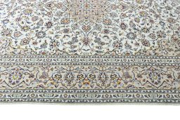 Corner detail of 2000s Kashan rug showing border pattern and Wool pile