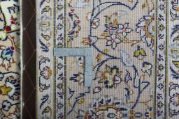 Backside of handmade 2000s Kashan rug showing knot structure and weave density
