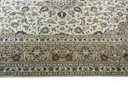 Corner detail of 2000s Kashan rug showing border pattern and Wool pile