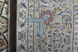 Backside of handmade 2000s Kashan rug showing knot structure and weave density