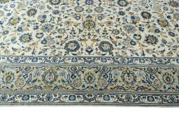 Corner detail of 2000s Kashan rug showing border pattern and Wool pile