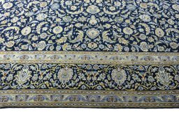 Corner detail of 2000s Kashan rug showing border pattern and Wool pile