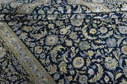 Close-up detail of 2000s Kashan rug from Iran / Persia showing Wool weave