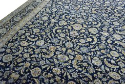 Backside of handmade 2000s Kashan rug showing knot structure and weave density