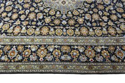 Corner detail of 2000s Kashan rug showing border pattern and Wool pile