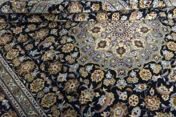 Close-up detail of 2000s Kashan rug from Iran / Persia showing Wool weave