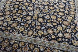 Close-up detail of 2000s Kashan rug from Iran / Persia showing Wool weave
