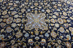 Corner detail of 2000s Kashan rug showing border pattern and Wool pile