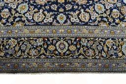 Backside of handmade 2000s Kashan rug showing knot structure and weave density
