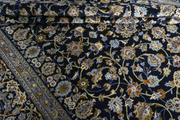 Close-up detail of 2000s Kashan rug from Iran / Persia showing Wool weave