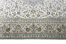 Corner detail of New Kashan rug showing border pattern and Wool pile
