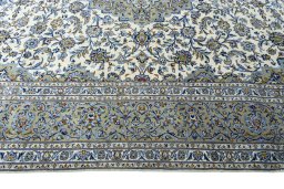 Corner detail of 2000s Kashan rug showing border pattern and Wool pile