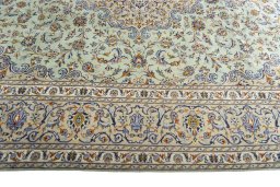 Corner detail of 2000s Kashan rug showing border pattern and Wool pile