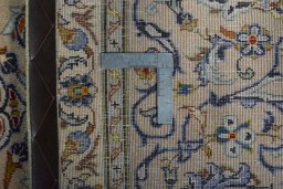 Backside of handmade 2000s Kashan rug showing knot structure and weave density