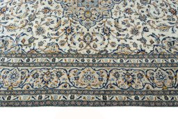 Corner detail of New Kashan rug showing border pattern and Wool pile