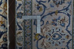 Backside of handmade New Kashan rug showing knot structure and weave density