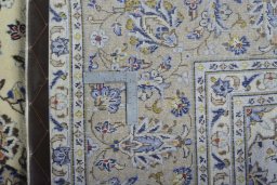 Backside of handmade New Kashan rug showing knot structure and weave density