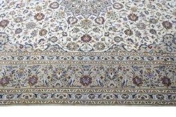 Corner detail of 2000s Kashan rug showing border pattern and Wool pile