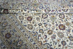 Close-up detail of 2000s Kashan rug from Iran / Persia showing Wool weave