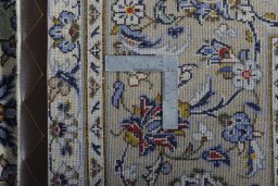 Backside of handmade 2000s Kashan rug showing knot structure and weave density