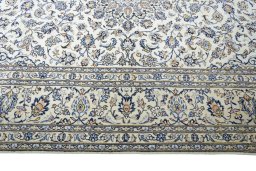 Corner detail of 2000s Kashan rug showing border pattern and Wool pile