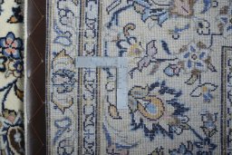 Backside of handmade 2000s Kashan rug showing knot structure and weave density