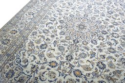 Backside of handmade 2000s Kashan rug showing knot structure and weave density