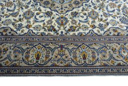 Corner detail of 2000s Kashan rug showing border pattern and Wool pile