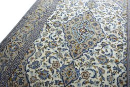 Backside of handmade 2000s Kashan rug showing knot structure and weave density