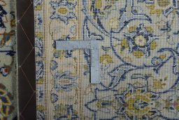 Backside of handmade 2000s Kashan rug showing knot structure and weave density