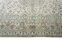 Corner detail of 2000s Kashan rug showing border pattern and Wool pile