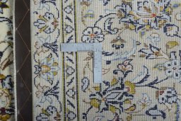 Backside of handmade 2000s Kashan rug showing knot structure and weave density