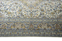 Corner detail of 2000s Kashan rug showing border pattern and Wool pile