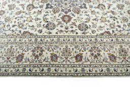 Corner detail of 2000s Kashan rug showing border pattern and Wool pile