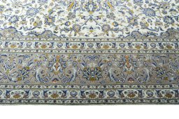 Corner detail of 2000s Kashan rug showing border pattern and Wool pile