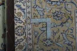 Backside of handmade 2000s Kashan rug showing knot structure and weave density