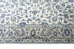 Corner detail of 2000s Kashan rug showing border pattern and Wool pile