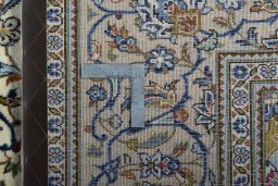 Backside of handmade New Kashan rug showing knot structure and weave density