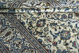 Corner detail of 2000s Kashan rug showing border pattern and Wool pile