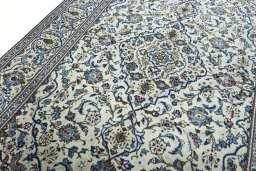 Backside of handmade 2000s Kashan rug showing knot structure and weave density