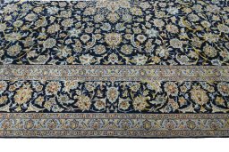 Corner detail of 2000s Kashan rug showing border pattern and Wool pile