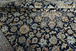 Close-up detail of 2000s Kashan rug from Iran / Persia showing Wool weave