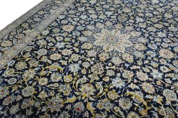 Backside of handmade 2000s Kashan rug showing knot structure and weave density
