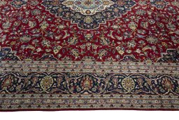 Corner detail of New Kashan rug showing border pattern and Cork pile