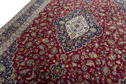 Backside of handmade New Kashan rug showing knot structure and weave density