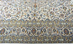 Corner detail of 2000s Kashan rug showing border pattern and Wool pile
